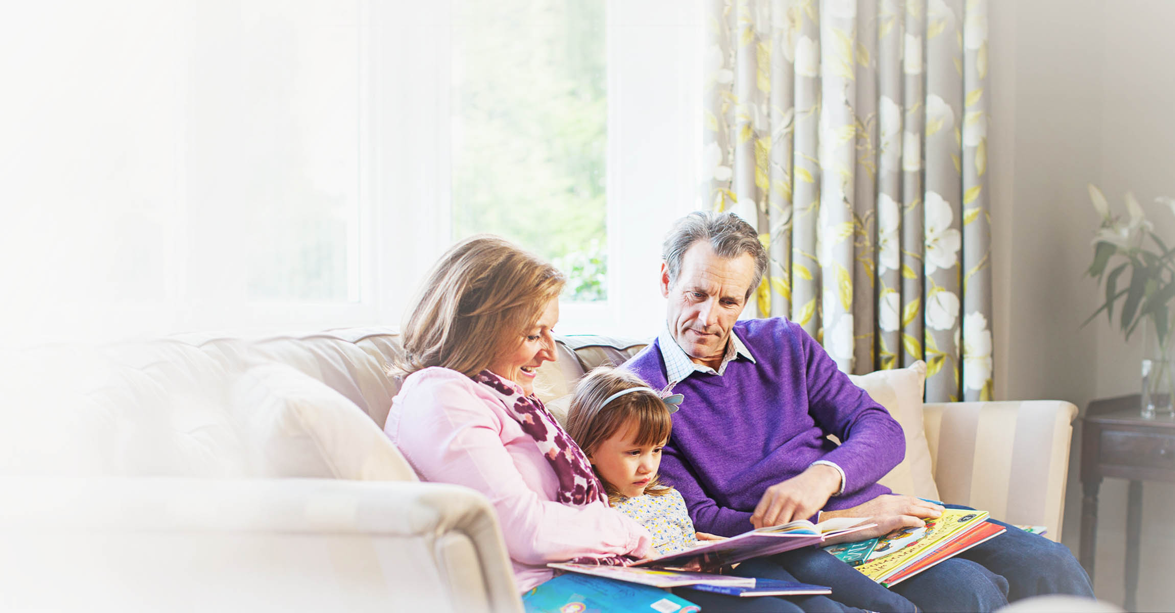 family on sofa reading
