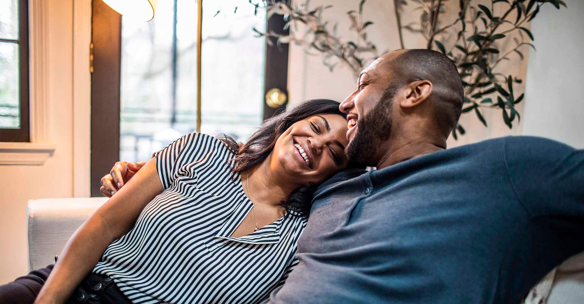 Smiling couple on sofa