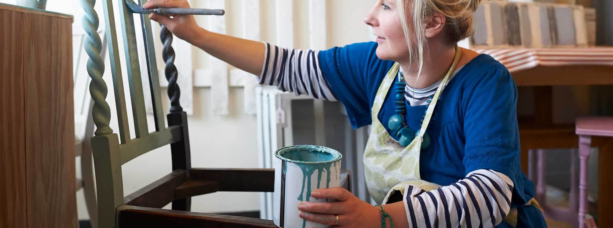 woman painting chair