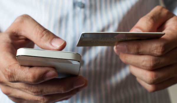 Man using card to pay on phone