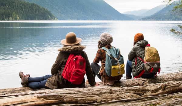 friends sitting near water