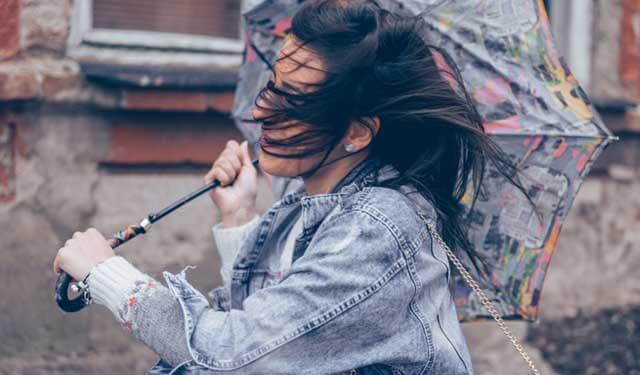 Woman with inside out umbrella