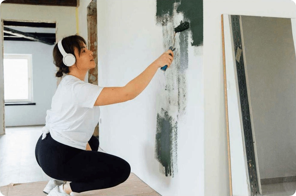 Woman painting wall