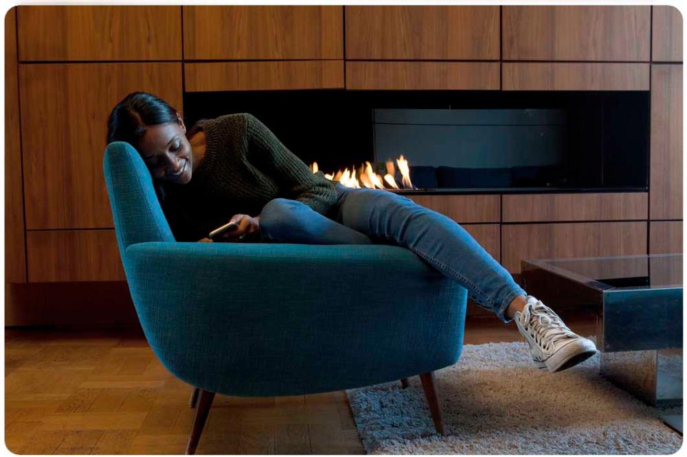 Woman relaxing in chair while looking at phone