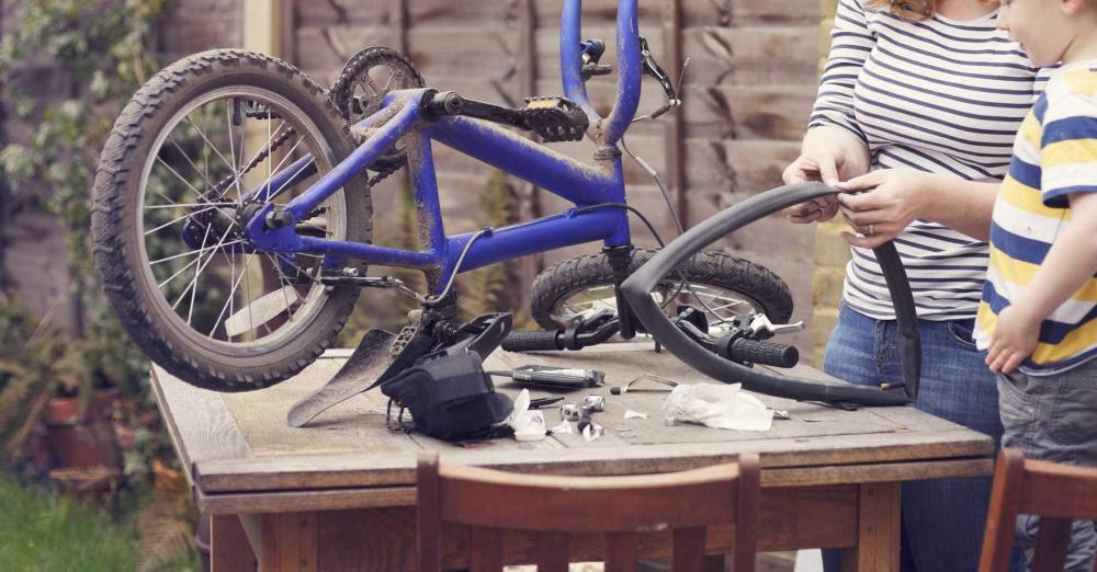 Mother and son fixing bicycle